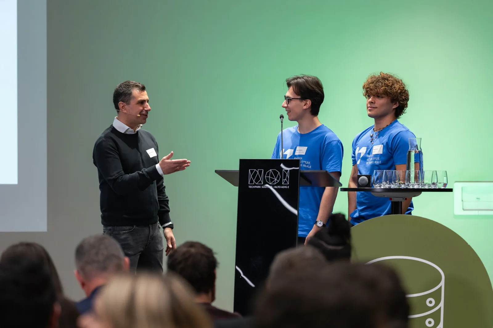 The PadoVia team on stage during a talk